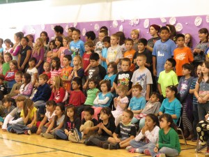 My grandson JJ is in the second row sitting next to a little blond girl and he has a blue shirt and red hair. He sticks out since he is I think the only redhead in his class. 