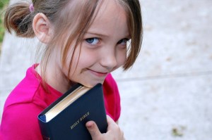 little-girl-with-bible-outside-church